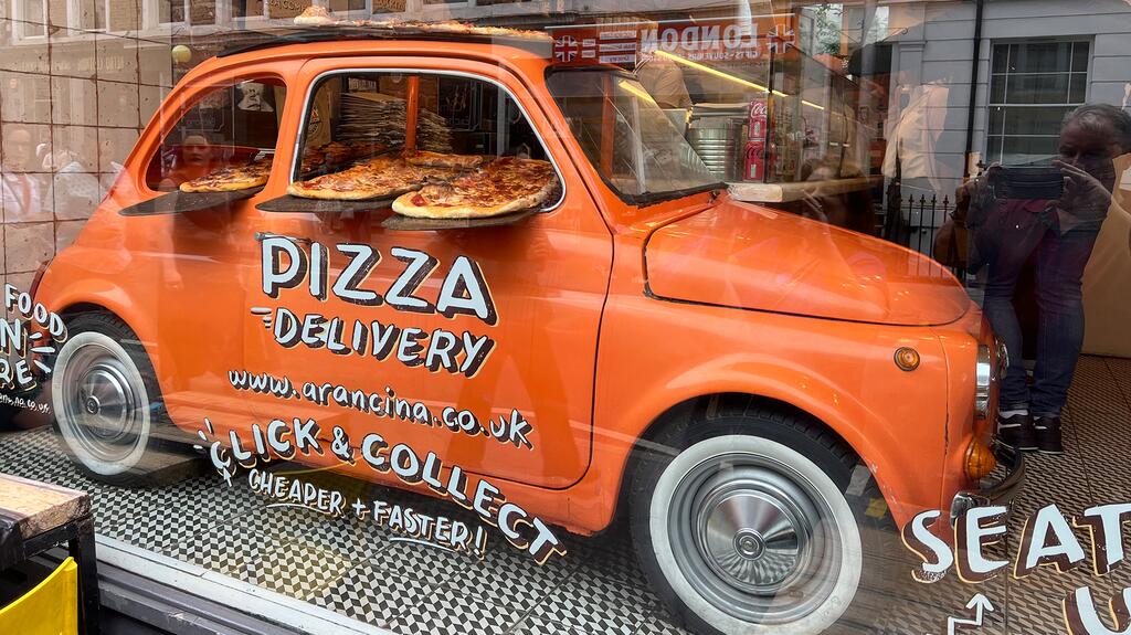 Smith also took a picture of this cleverly repurposed car he spotted in the window of a pizza shop. Pizza Fiat Camden Market
