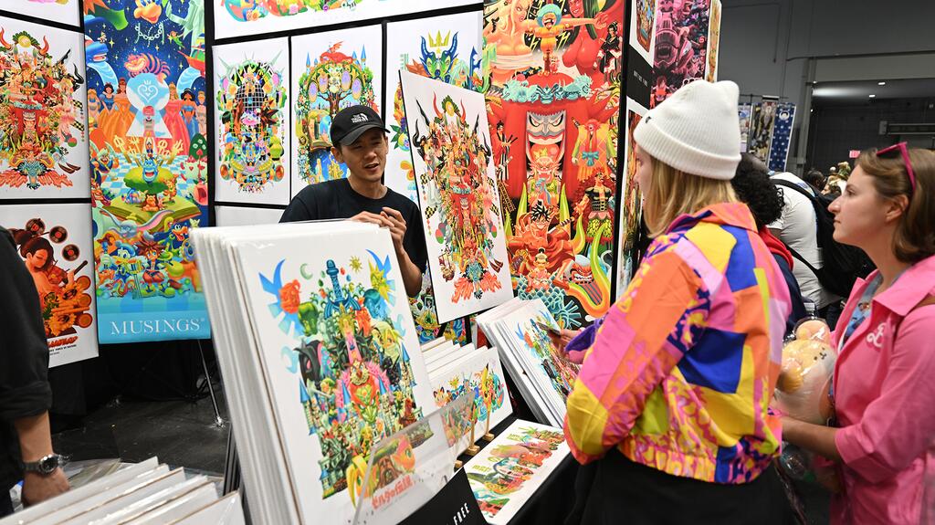 Attendees stop by a booth at New York Comic Con. (Image credit: Roy Rochlin/Getty Images for ReedPop) New York Comic Con attendees at a booth