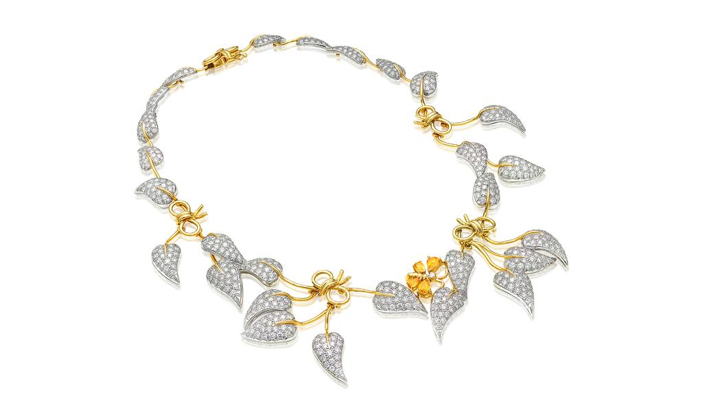 A Schlumberger for Tiffany & Co. necklace featuring pavé-set diamond leaves, gold stems and bows, and a gem-set butterfly Schlumberger for Tiffany & Co. diamond and gold leaves necklace