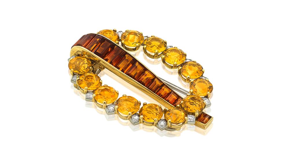 A Cartier “buckle” clip brooch set with diamonds and citrines Cartier diamond and citrine buckle brooch