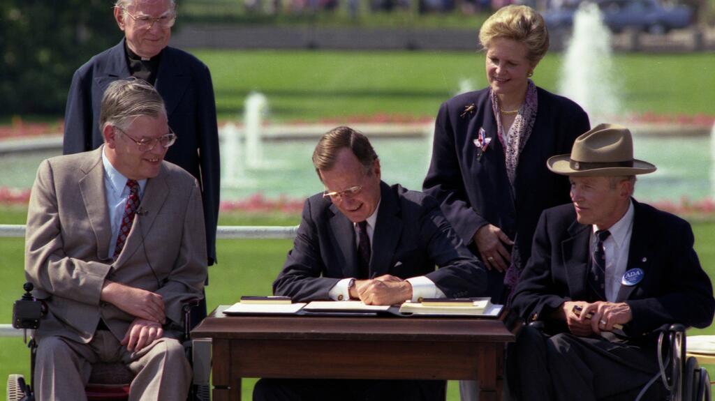 President George H. W. Bush signed the Americans with Disabilities Act into law on July 26, 1990. (Image credit: National Archives) President George H. W. Bush signing the Americans with Disabilities Act