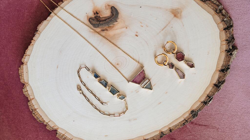 Chouette Designs is a San Diego-based jewelry brand that centers inclusivity in its business. Seen here are pieces from the “Ember” collection featuring sapphire slices set in 14-karat gold Chouette Designs Ember jewelry collection