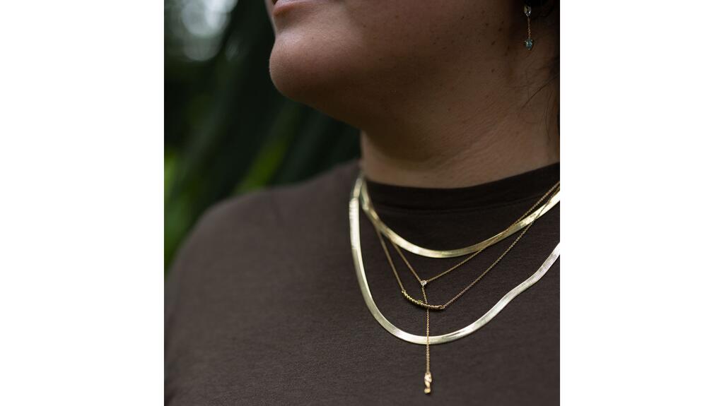 Chouette Designs said it aims to create "beautiful, size-inclusive, and gender-affirming designs." Chouette Designs necklaces on model