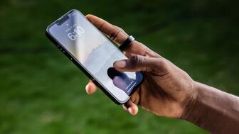 A shot from the digital campaign for the Ultrahuman Ring Air, a smart ring that’s now being sold by Verizon in the United States. Retailing for about $350, the ring can tell the wearer about their movements and sleep patterns. A person wearing the Ultrahuman Ring Air smart ring while holding a cell phone