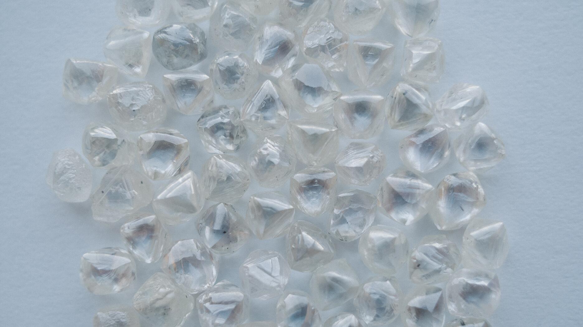 An assortment of rough diamonds mined by De Beers Group. The company announced that it will now list the country of origin for each rough diamond it mines that weighs above 1.25 carats. In 2025, the change will expand to include diamonds that weigh more than 1 carat. Stock image of rough diamonds