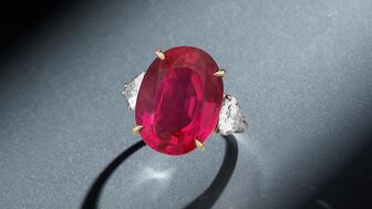 Red and green gemstones dominated at Phillips’ Geneva jewelry auction Monday, with this 17.97-carat Burmese ruby ring leading the way. A buyer paid $5.4 million for the ring, at the top end of its estimated range. (Photo courtesy of Phillips) 17.97-carat Burmese ruby ring with pear-shaped diamonds