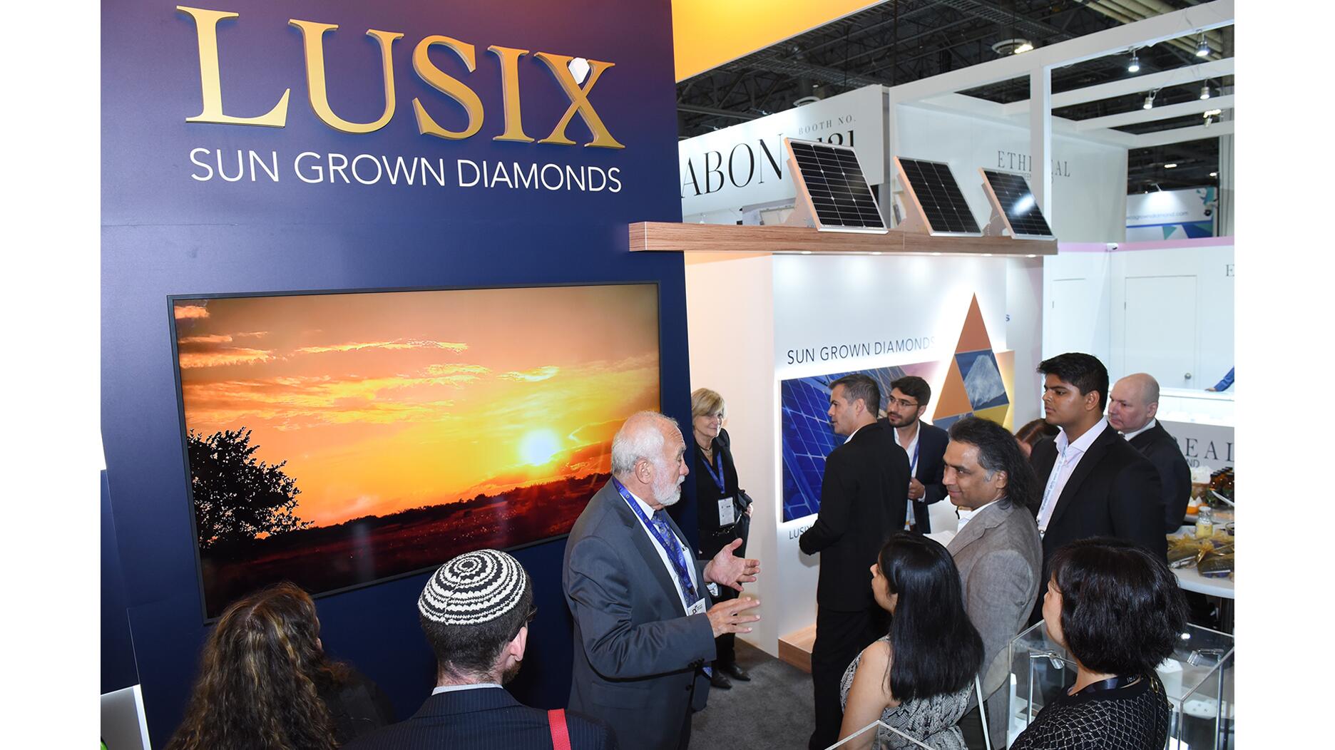 Lusix founder Benny Landa, center, in the lab-grown diamond company’s booth at JCK Las Vegas 2022, where it announced it had just completed a $90 million round of funding. Now deep in debt, Lusix filed for temporary protection from creditors in August, and was just sold to two other lab-grown diamond companies. Lusix Lab Grown Diamonds at JCK Las Vegas 2022