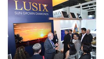 Lusix founder Benny Landa, center, in the lab-grown diamond company’s booth at JCK Las Vegas 2022, where it announced it had just completed a $90 million round of funding. Now deep in debt, Lusix filed for temporary protection from creditors in August, and was just sold to two other lab-grown diamond companies. Lusix Lab Grown Diamonds at JCK Las Vegas 2022