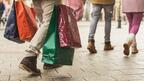 People outside holding shopping bags