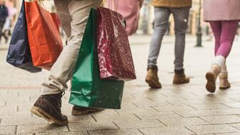 Around 126 million consumers did their holiday shopping in stores this season, up from 121.4 million last year, with Small Business Saturday faring particularly well, the National Retail Federation’s annual Thanksgiving weekend survey shows. The number of online shoppers, meanwhile, declined 7 percent. People outside holding shopping bags