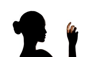Wearables company Ultrahuman debuted a new line of 18-karat gold and platinum smart rings. Woman’s silhouette with smart ring on finger