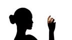 Woman’s silhouette with smart ring on finger
