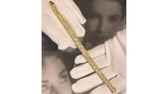 Elizabeth Taylor once owned this diamond line bracelet featuring 27 graduated, radiant-cut, yellow-tinted diamonds. U.K. auction house Woolley & Wallis is putting it up for sale later this month, with an estimated sale price of £50,000-£70,000 (approximately $61,000-$86,000). (Photo courtesy of Woolley & Wallis) Elizabeth Taylor diamond line bracelet