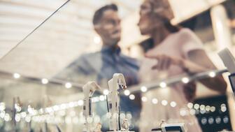 The Conference Board’s Consumer Confidence Index declined again in January, slipping to 104.1. Consumers surveyed were more pessimistic about the current job market and are concerned about lingering inflation and recent signals from the Federal Reserve that the pace of interest rate cuts will slow in 2025. Stock image of couple shopping for jewelry
