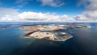 Rio Tinto, which owns and operates Canada’s Diavik Diamond Mine, reported that production at the mine, pictured here in warmer months, dropped 17 percent last year while revenue was down 37 percent. (Photo courtesy of Rio Tinto) Canada’s Diavik Diamond Mine in warmer months