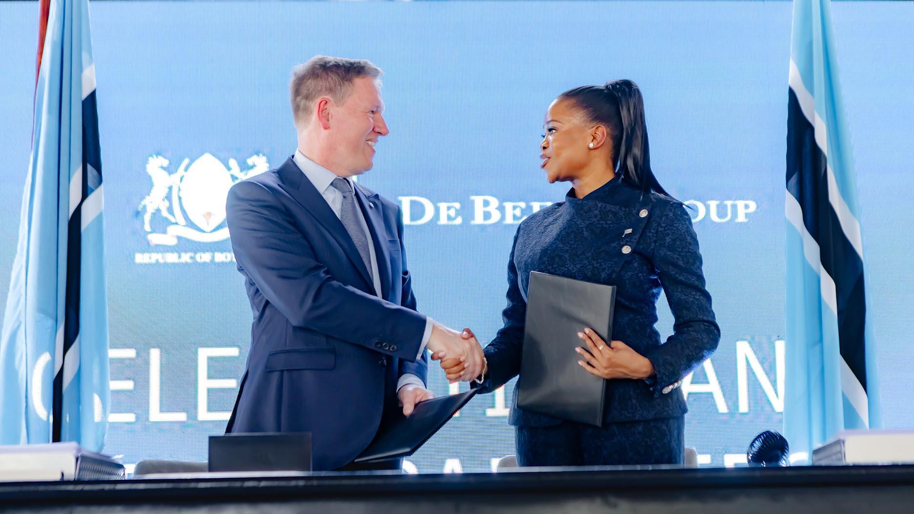 Botswana Minster of Minerals and Energy Bogolo Joy Kenewendo, right, shakes hands with De Beers Group CEO Al Cook Tuesday at the official signing of the new 10-year sales agreement between the diamond miner and marketer and the Botswana government. (Photo courtesy of De Beers Group) De Beers CEO Al Cook, Botswana Minster of Minerals and Energy Bogolo Joy Kenewendo
