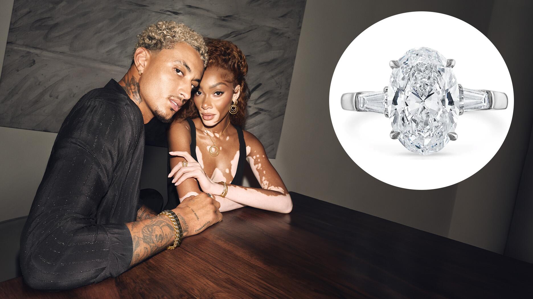 Winnie Harlow and Kyle Kuzma, pictured in David Yurman’s 2024 holiday campaign, are engaged after almost five years of dating. Kuzma proposed on Valentine’s Day with a three-stone ring, a style that continues to be popular for engagement rings. Pictured at right is a three-stone ring from Stephanie Gottlieb Fine Jewelry featuring a 3-carat oval-cut center stone flanked by tapered baguette side stones. Winnie Harlow, Kyle Kuzma, Stephanie Gottlieb Fine Jewelry Engagement Ring