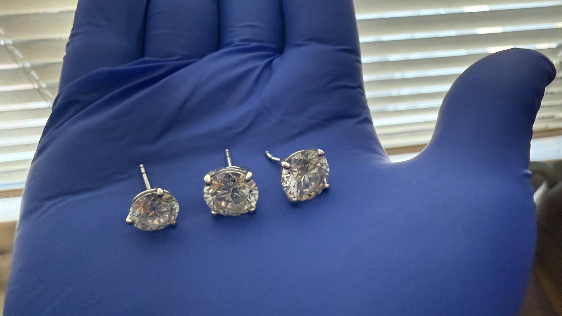 Orlando Police Department detectives recovered the earrings stolen from the Tiffany & Co. store in the Mall of Millenia on Feb. 26 and then swallowed by the man charged in the case. Three of the earrings were recovered on March 10 and the fourth on March 12. (Image courtesy of the Orlando Police Department) Diamond earrings held in gloved hand
