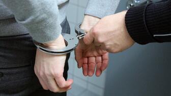 Former jewelry store employee Michel Patrick Desalles is accused of murdering his boss, Omid Gholian, according to the Manhattan District Attorney’s Office. Stock image of a man’s hands in handcuffs
