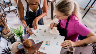 an instructor and a student in a bench jewelry classroom